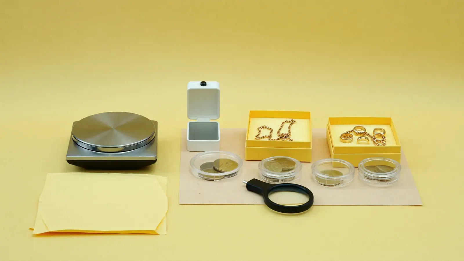 The kit for Coin and jewelry selling desk, laid out on a plain background