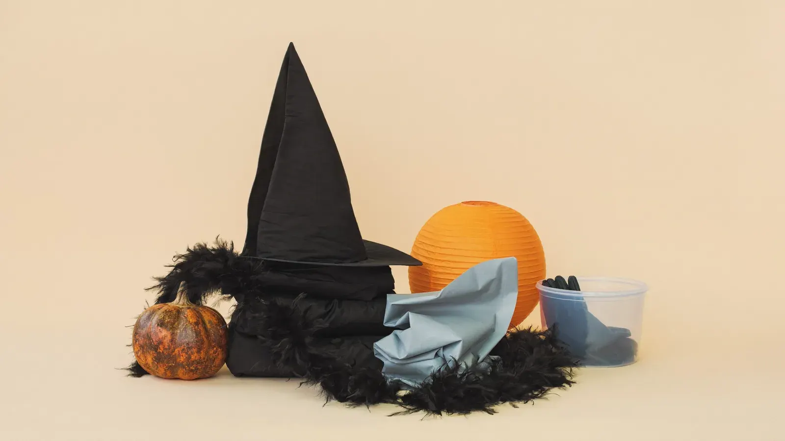 Halloween costume and decor rush from a garage: the kit, photographed as a studio still life
